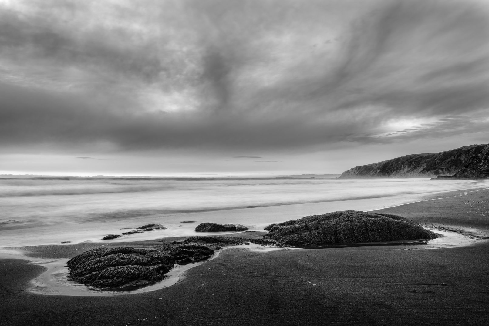 Beach with rocks and clouds