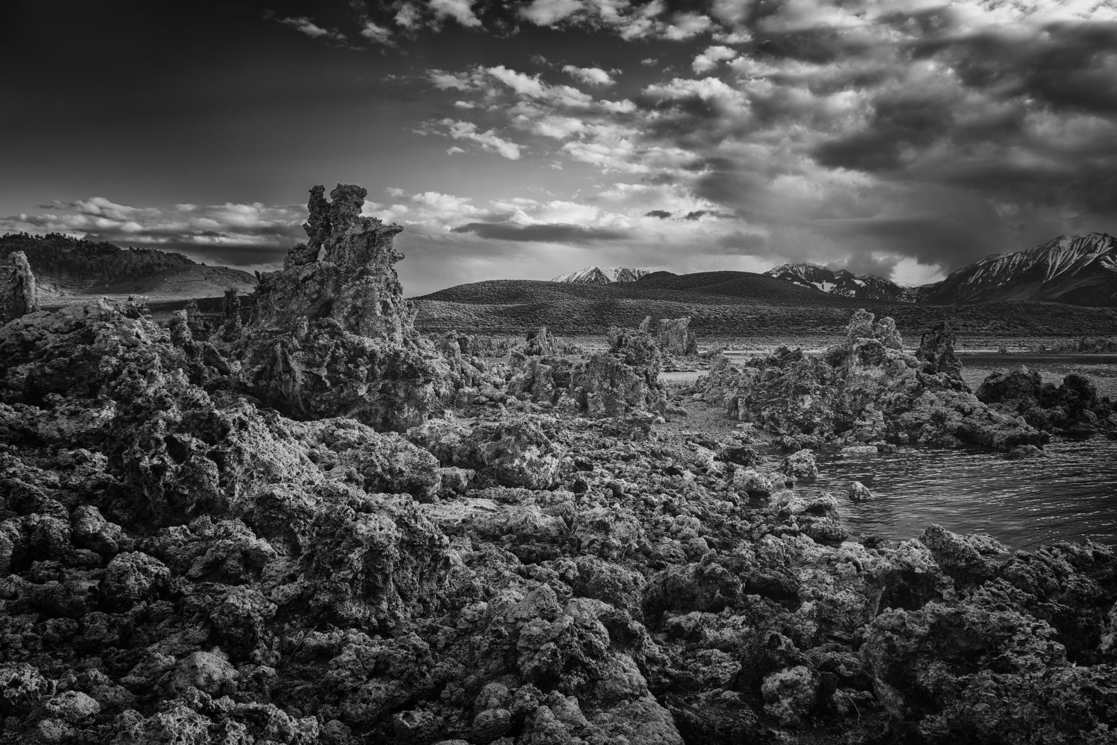 Mono Lake, California with rocks, mountains, and streaked clouds