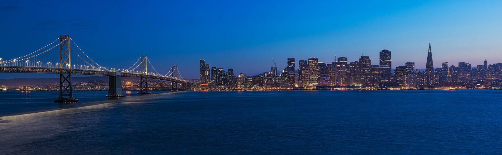 San Francisco skyline and Oakland Bay Bridge at twilight