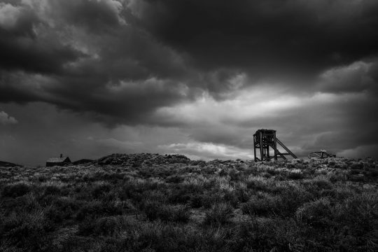 bodie-1 Old tower with stormy clouds in Bodi, California ghost town