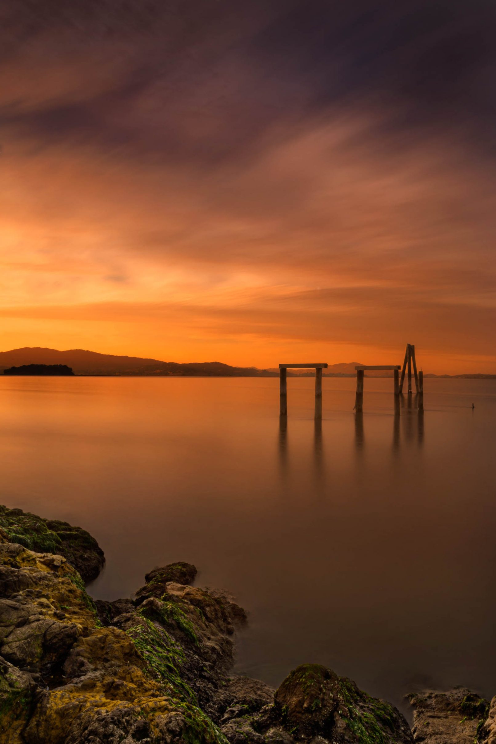 San Pablo Bay, California with rocks, sticks, and sunset