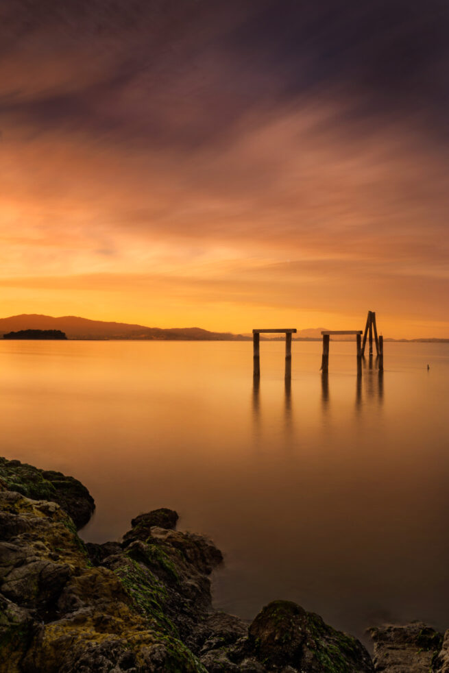 San Pablo Bay, California with rocks, sticks, and sunset