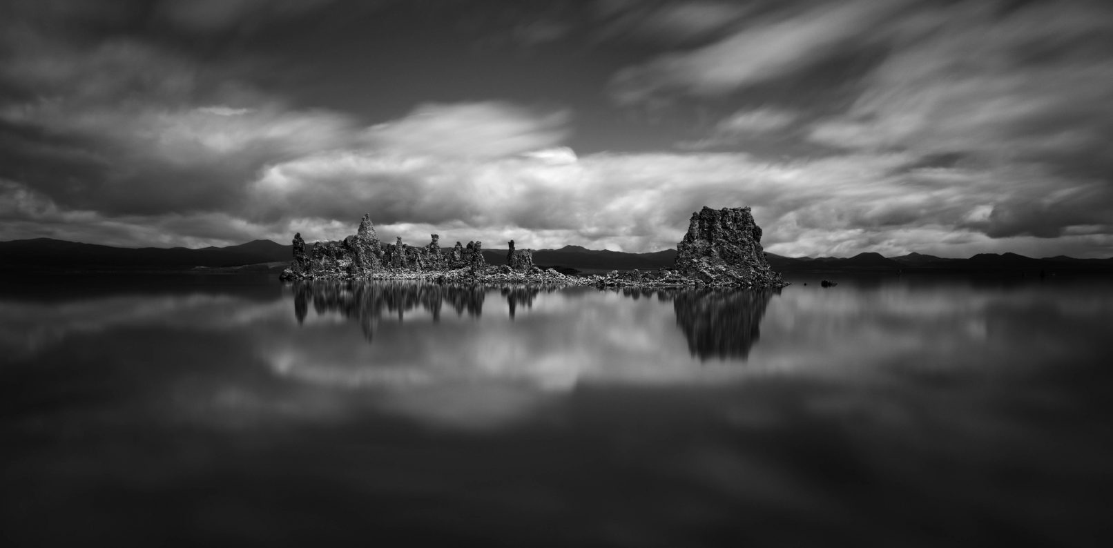 Rock formations in Mono Lake, California with streaked clouds