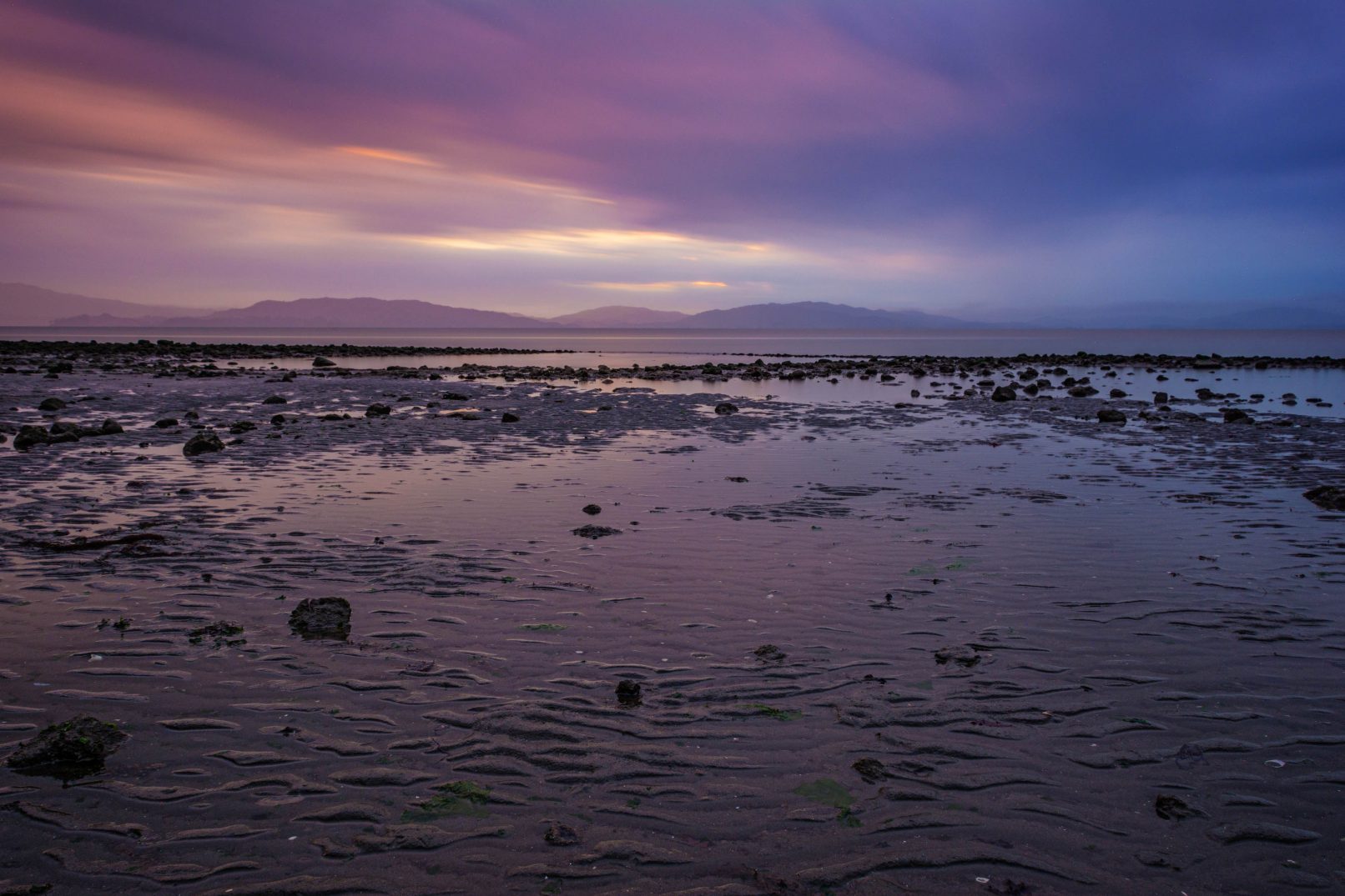 San Pablo Bay from Point Pinole with rocks and dramatic, lavender clouds