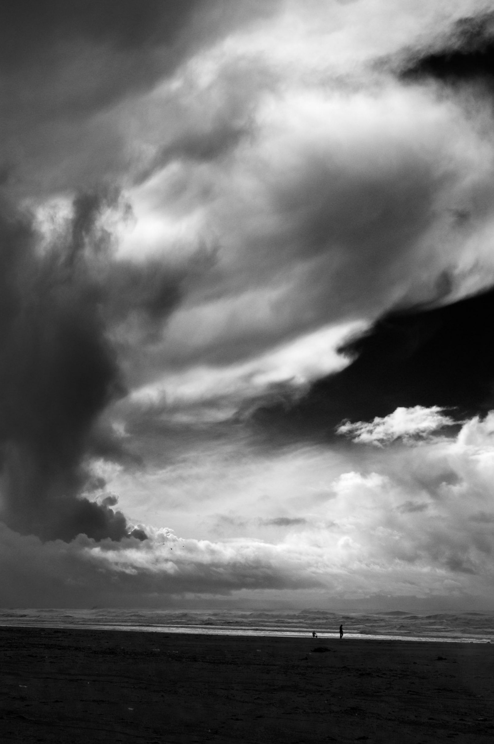 California Beach with stormy clouds and figures