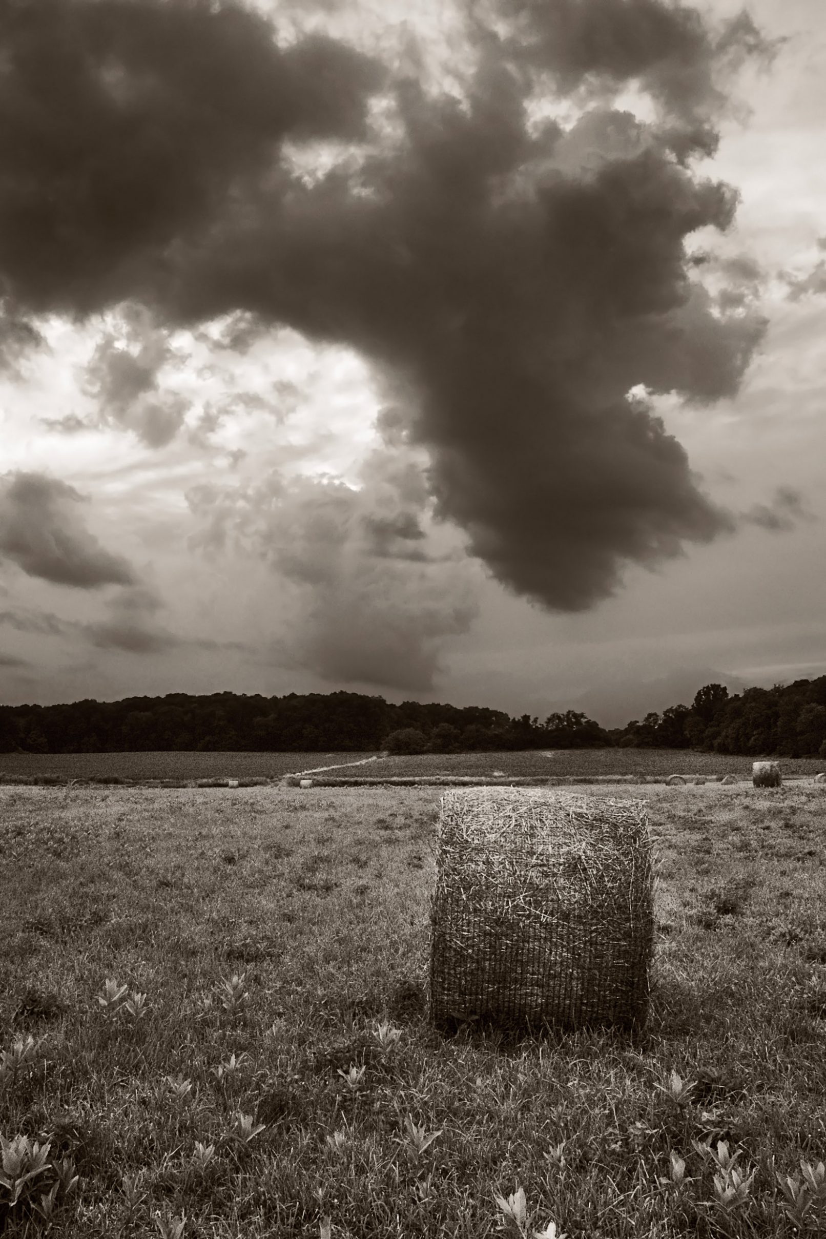 Haystack with stormy clouds