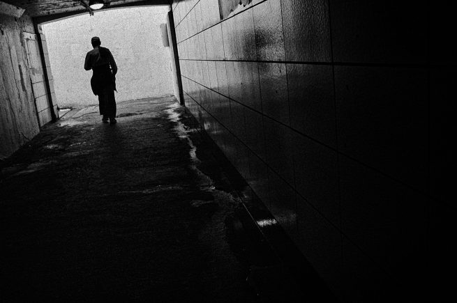 Man walking in dark tunnel