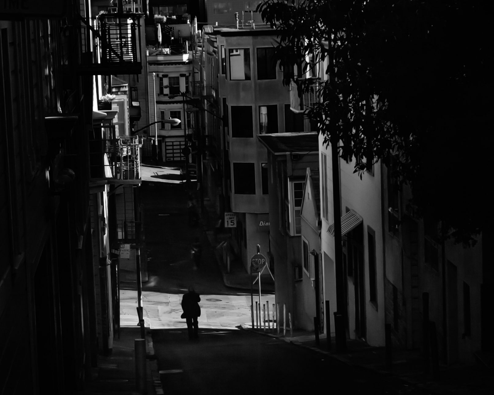 Man on street in San Francisco with dark shadows