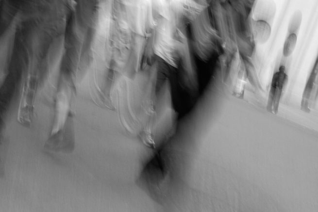 Blurred people walking on city street