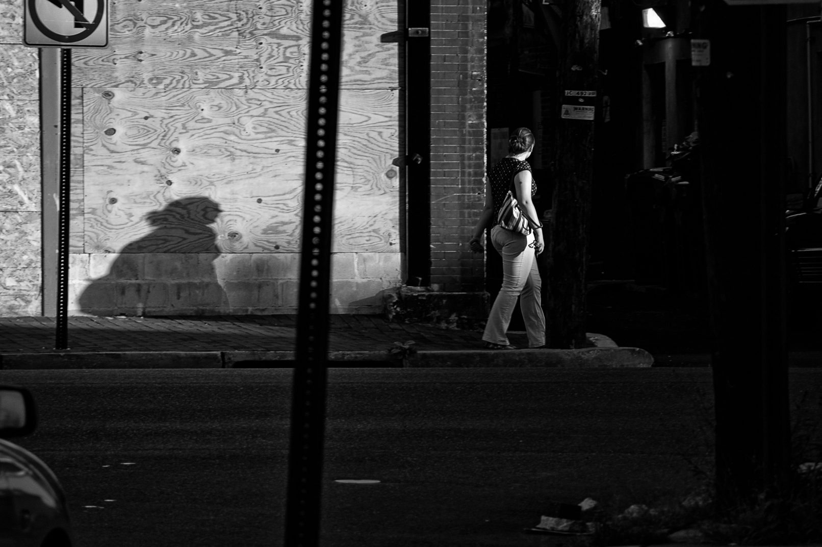 Woman on street with long shadow