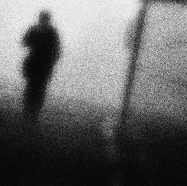 Man silhouette in tunnel with film grain