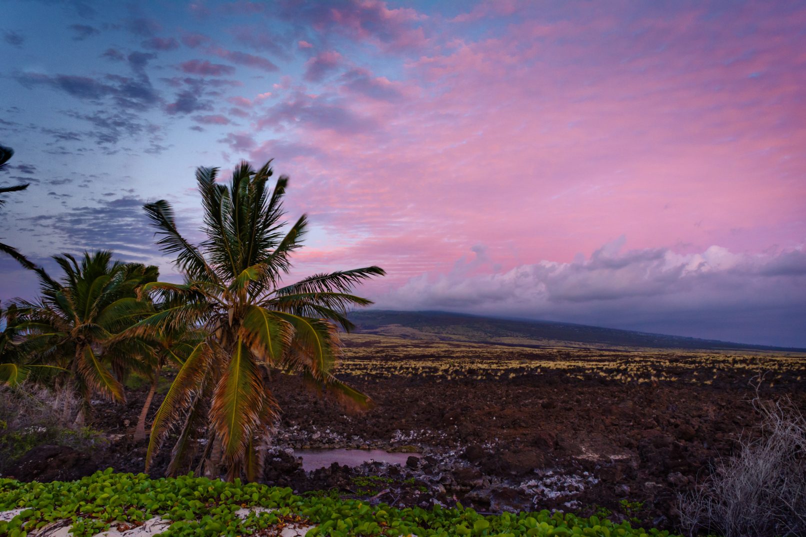 Hawaii, lava rock field with colored clouds between Mahai'ula Beach and Makalawena Beach