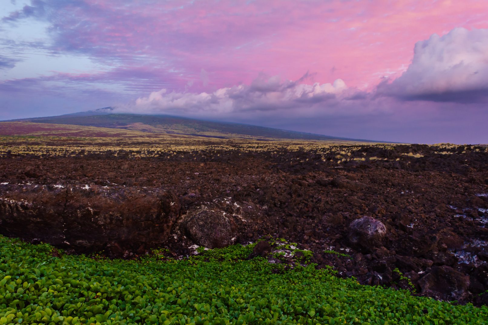 Hawaii, lava rock field with colored clouds between Mahai'ula Beach and Makalawena Beach