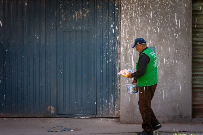 Peruvian man holding bucket
