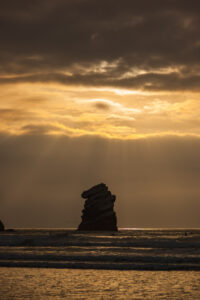 California beach sunset over rock