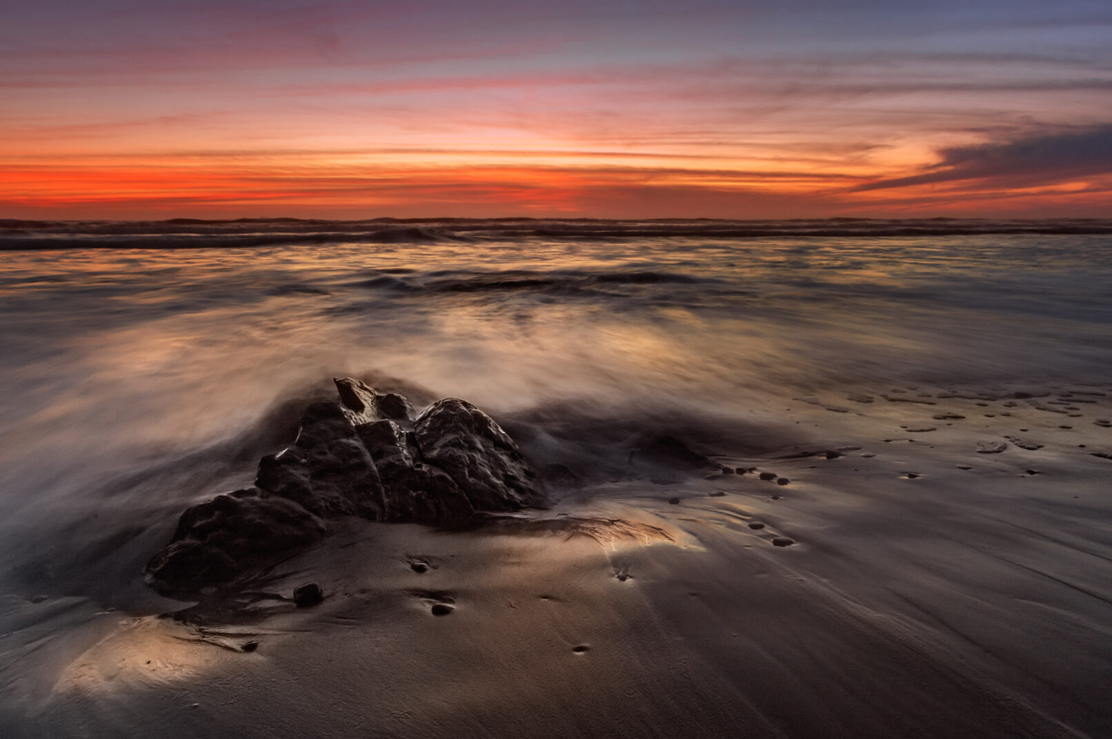 ocean waves with rock sunset